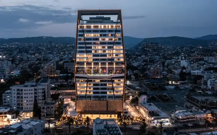 Icon Limassol residential tower illuminated at dusk