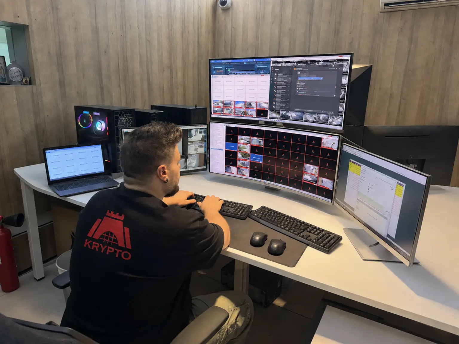 Krypto operator assessing live camera views in the Monitoring Operating Center