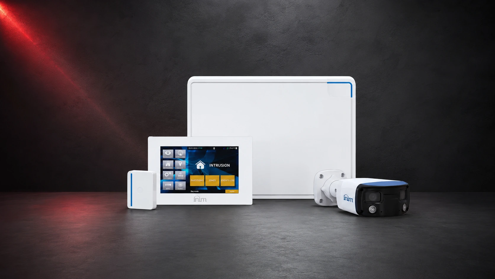 INIM intrusion system with control unit, touchscreen keypad, detection device and video verification camera on a coordinated studio background